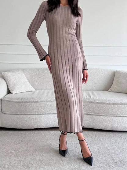 Model wearing a Contour Maxi Dress, showcasing ribbed knit elegance and a chic ankle-grazing silhouette.