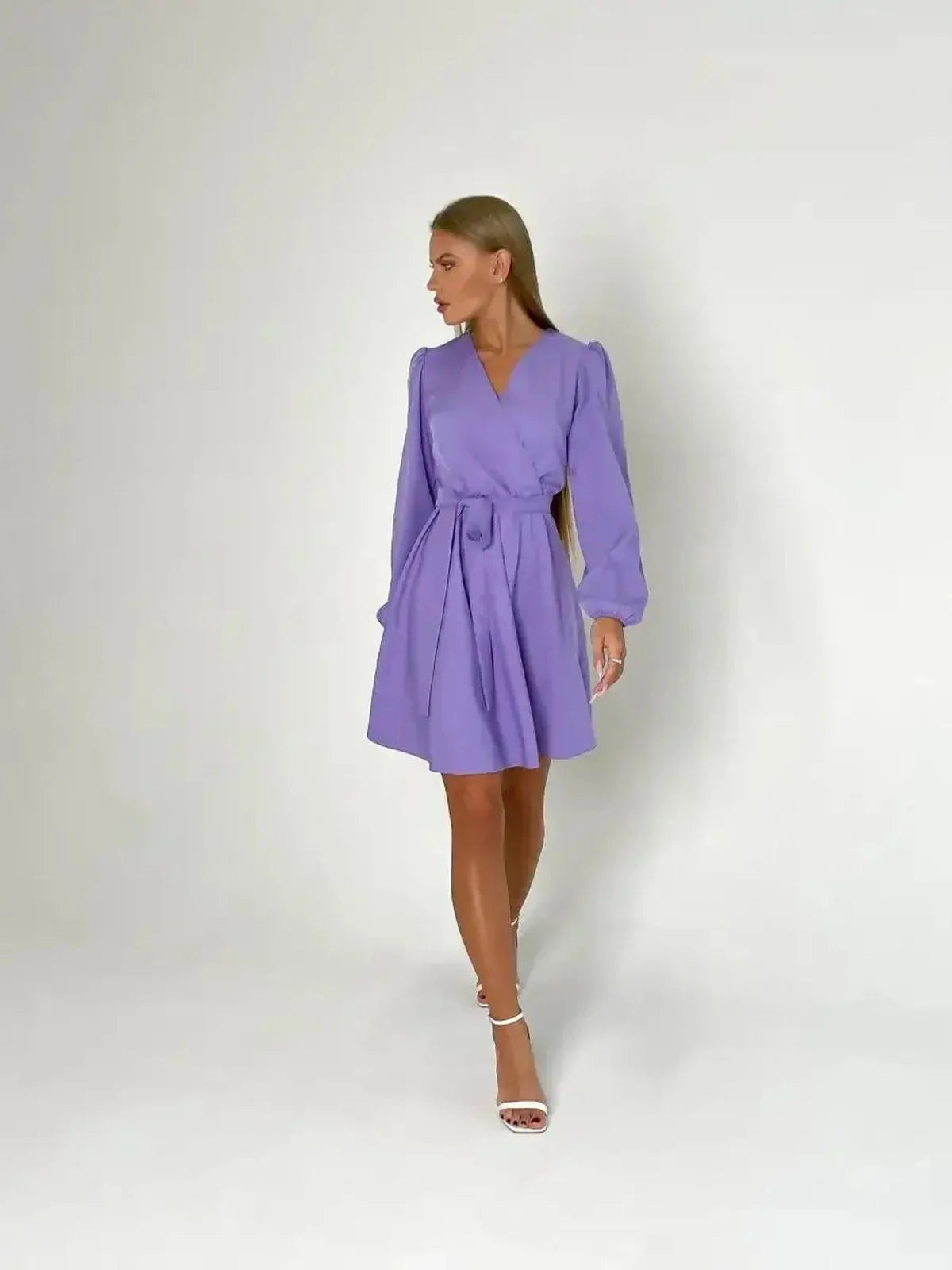 Lilac Charm mini dress featuring a V-neckline, long sleeves, and cinched waist with tie, exuding elegance and sophistication.
