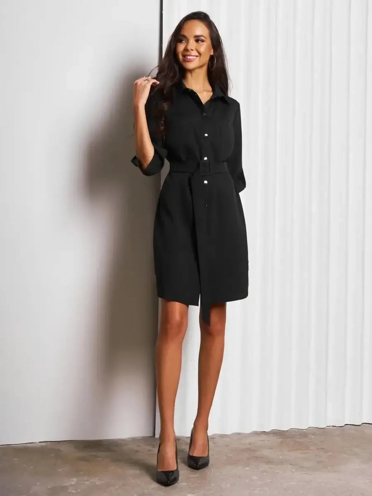 Model showcasing Urban Edit Mini black shirt dress with structured silhouette and detachable belt, perfect for versatile styling.