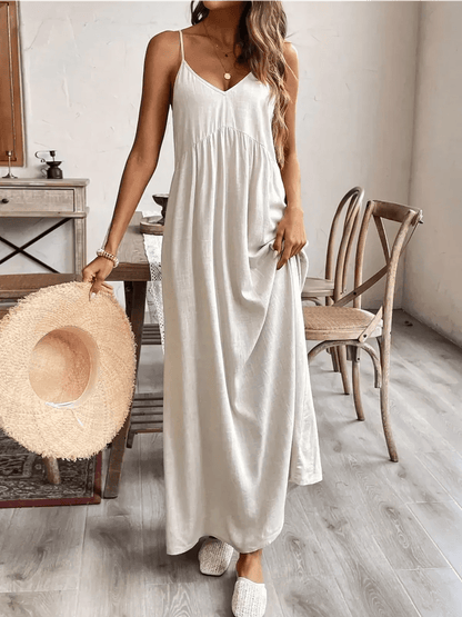 Serenity Maxi Dress in lightweight fabric, styled with a wide-brimmed hat and relaxed footwear, perfect for summer outings.