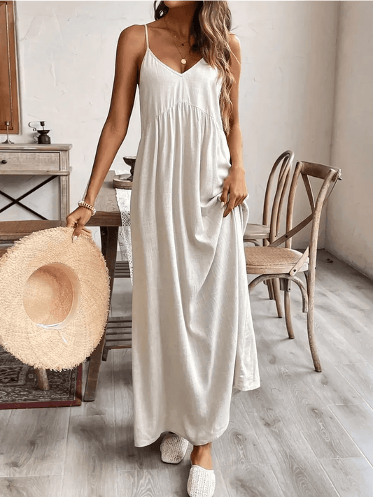 Serenity Maxi Dress in lightweight fabric, styled with a wide-brimmed hat and relaxed footwear, perfect for summer outings.