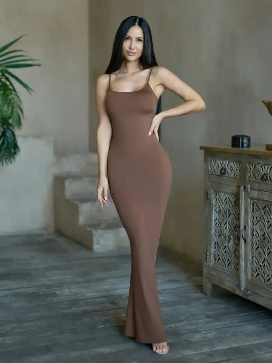 Model wearing Cocoa Curve Maxi Dress in deep brown, showcasing sleek silhouette and minimalistic style.