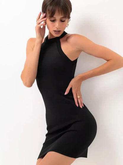 Model showcasing a sleek black midi dress with halter neckline and tailored fit for evening occasions.