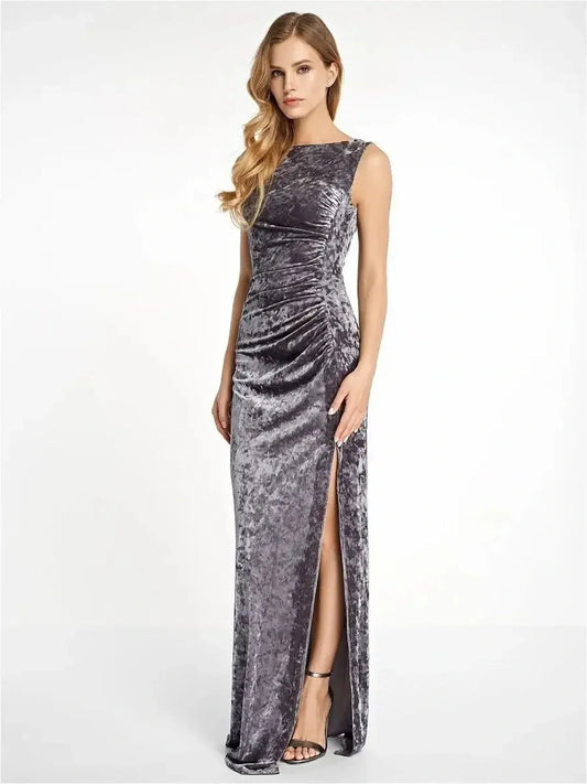 Elegant woman in Luxe Velvet Maxi Dress featuring ruched side and leg slit in crushed velvet texture.