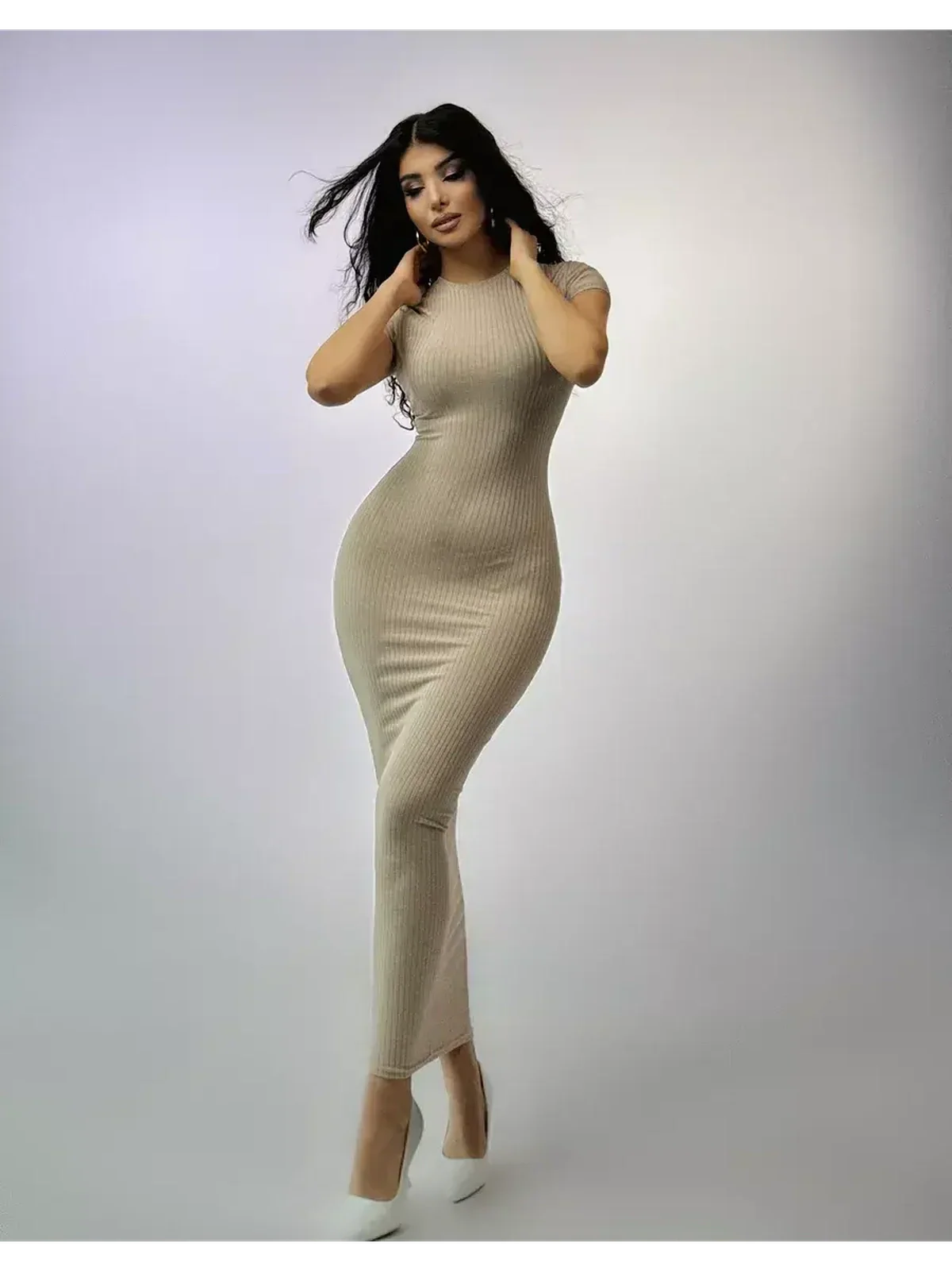 Model wearing the Contour Grace Maxi Dress in ribbed knit, showcasing a sculpted fit and elegant silhouette.