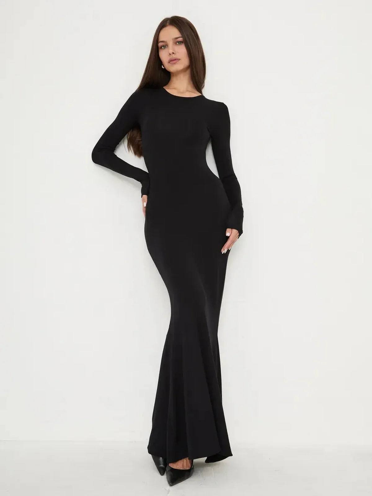 Elegant Sculpted Noir black dress featuring a sleek, fitted silhouette and mermaid hem for a dramatic look.