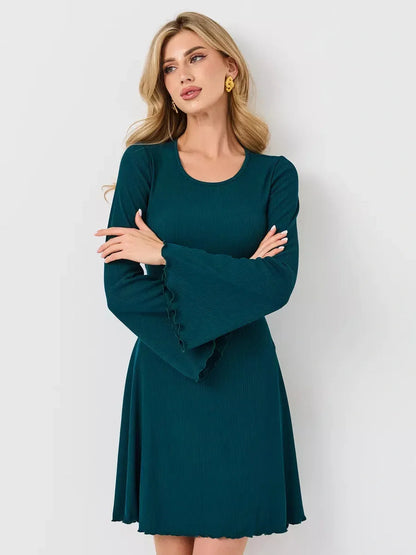 Emerald Whisper mini dress featuring a flared hem and bell sleeves, perfect for stylish occasions.