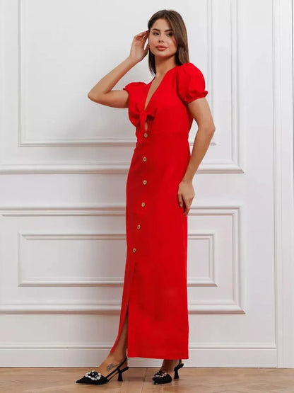 Maxi Dress Riviera Flame in bold red, featuring tie-front bodice, puff sleeves, and a full button-down skirt.
