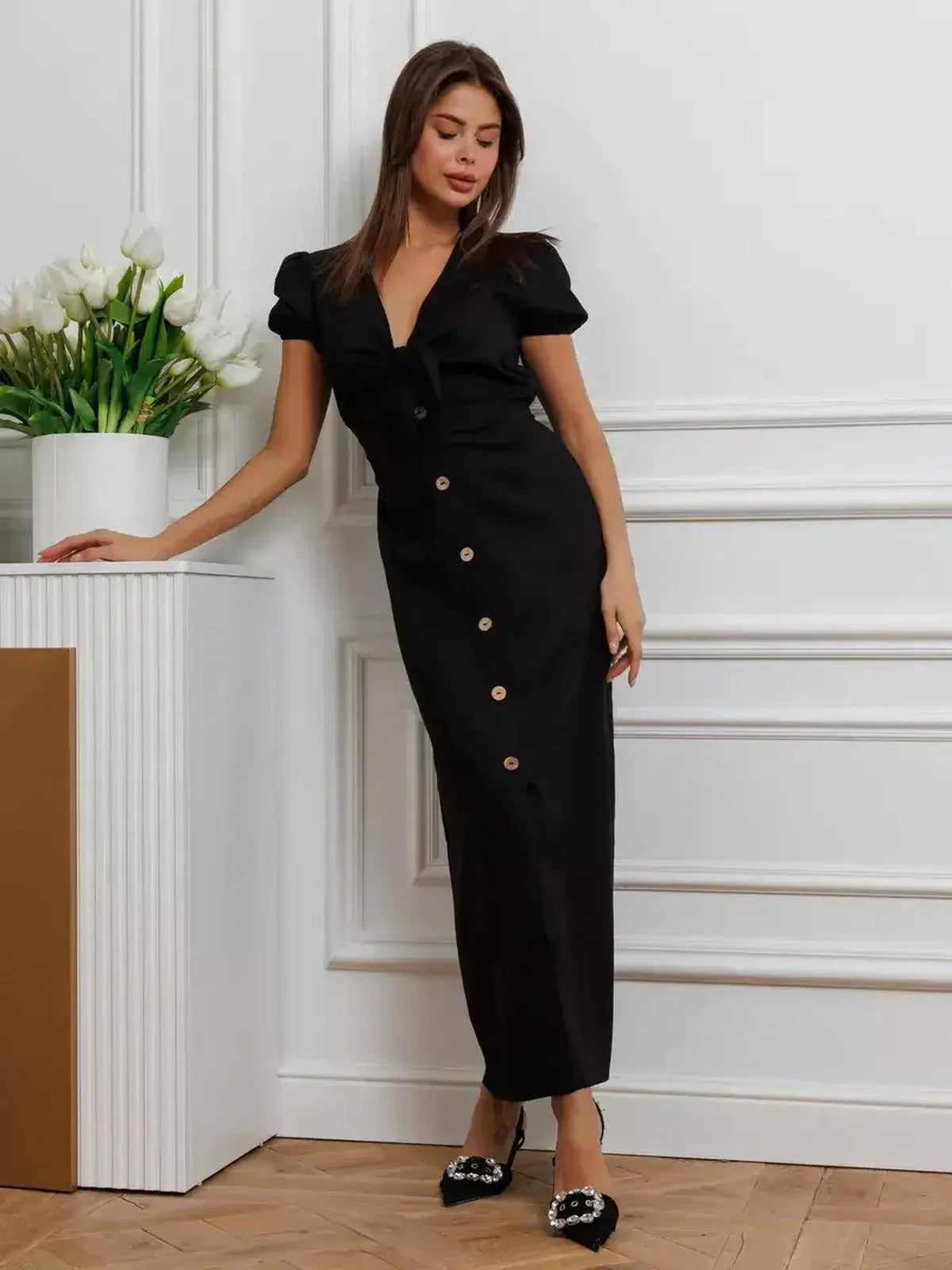 Elegant black Maxi Dress Noir Belle featuring a tie-front detail, puff sleeves, and contrast buttons for a timeless look.