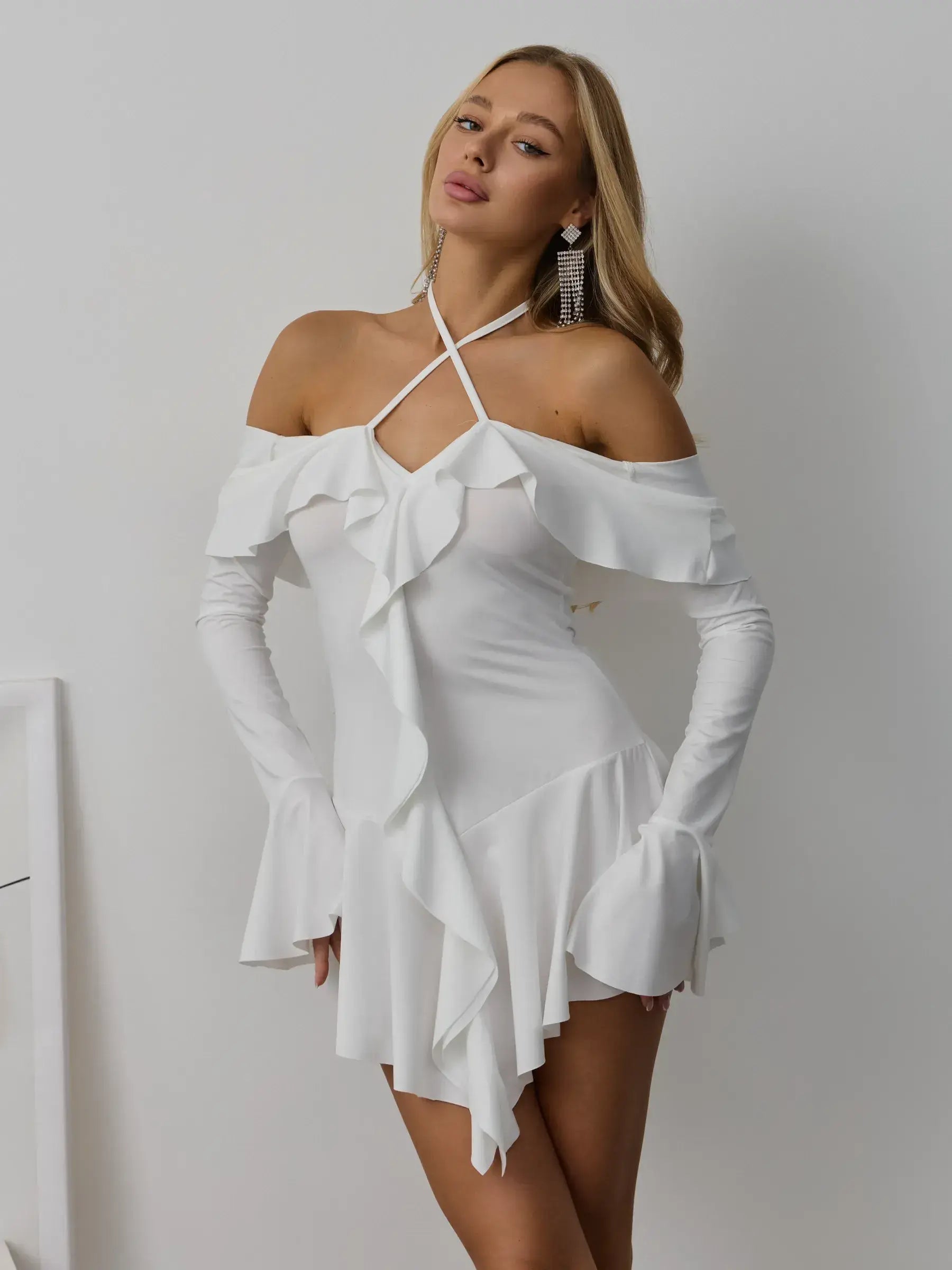 Velina Ruffle Dress in white, featuring off-the-shoulder design and cascading ruffles, perfect for summer weddings and formal occasions.
