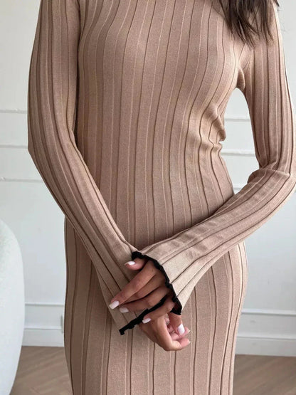 Close-up of Sahara Curve Maxi Dress in sandstone beige, showcasing soft ribbed texture and elegant long sleeves.