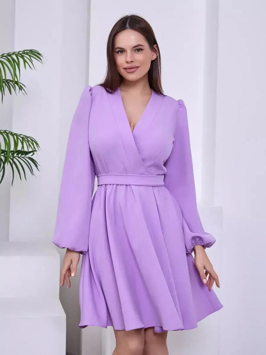 Lilac Whisper long sleeve dress with a V-neckline and cinched waist, showcasing elegance and refined style.