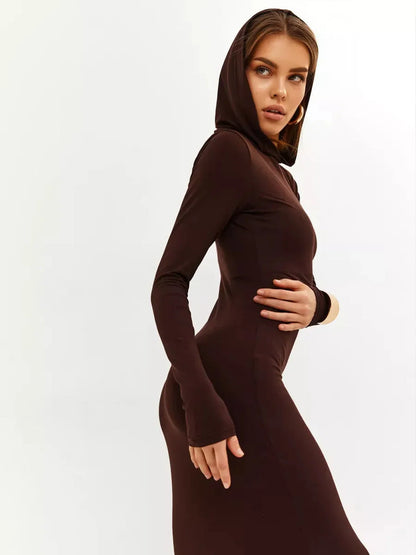 Model in a hooded Sculpt Maxi Dress showcasing a sleek silhouette in rich chocolate tone.
