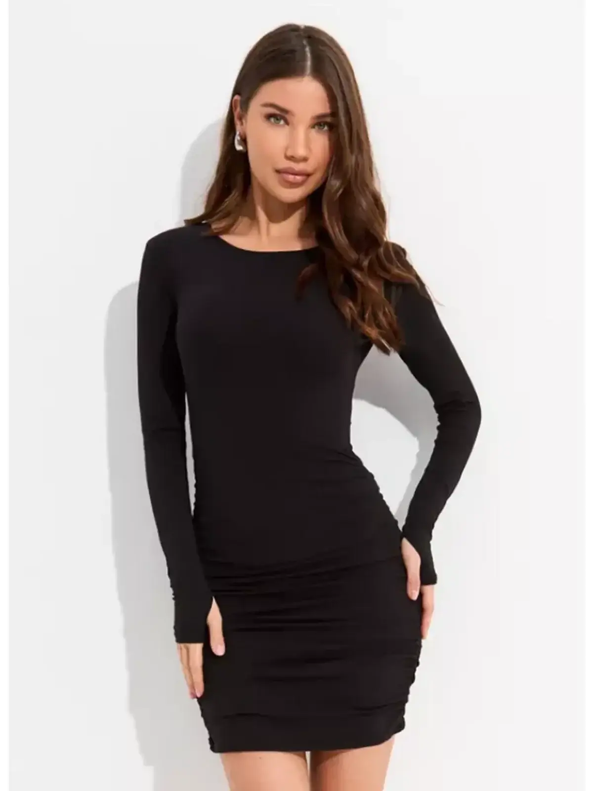 Model wearing a black long sleeve mini dress with side ruching, perfect for cocktail or formal occasions.
