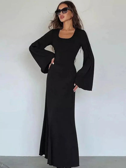 Elegant noir contour maxi dress featuring flared sleeves and a sculpting silhouette.