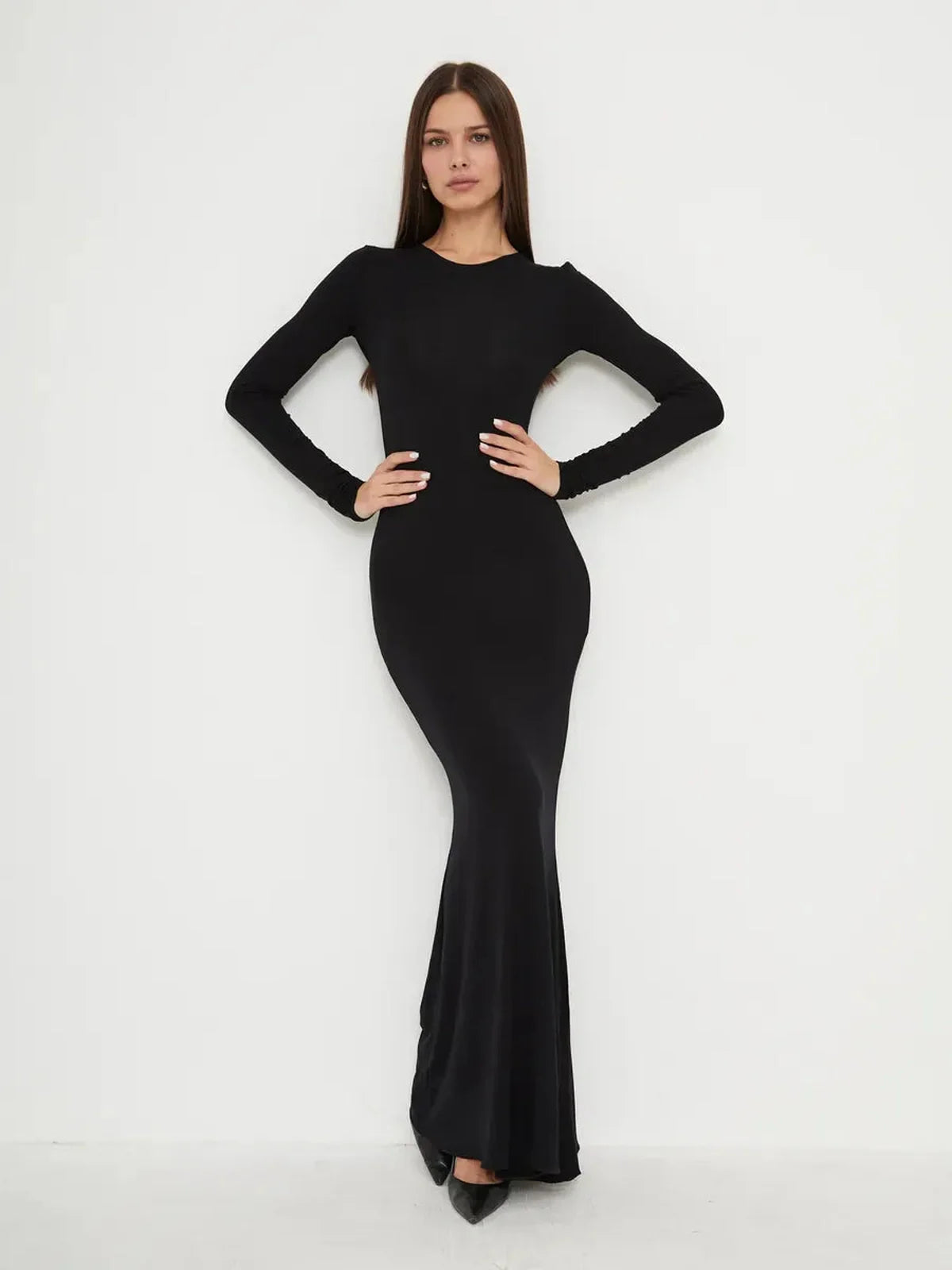 Elegant black full-length dress with long sleeves and mermaid hem, showcasing a sleek, second-skin fit.