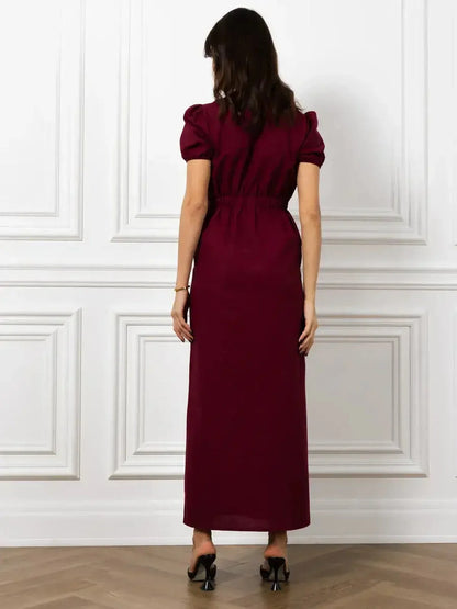 Back view of the elegant Maxi Dress Merlot Grace with structured puff sleeves and a flattering silhouette.