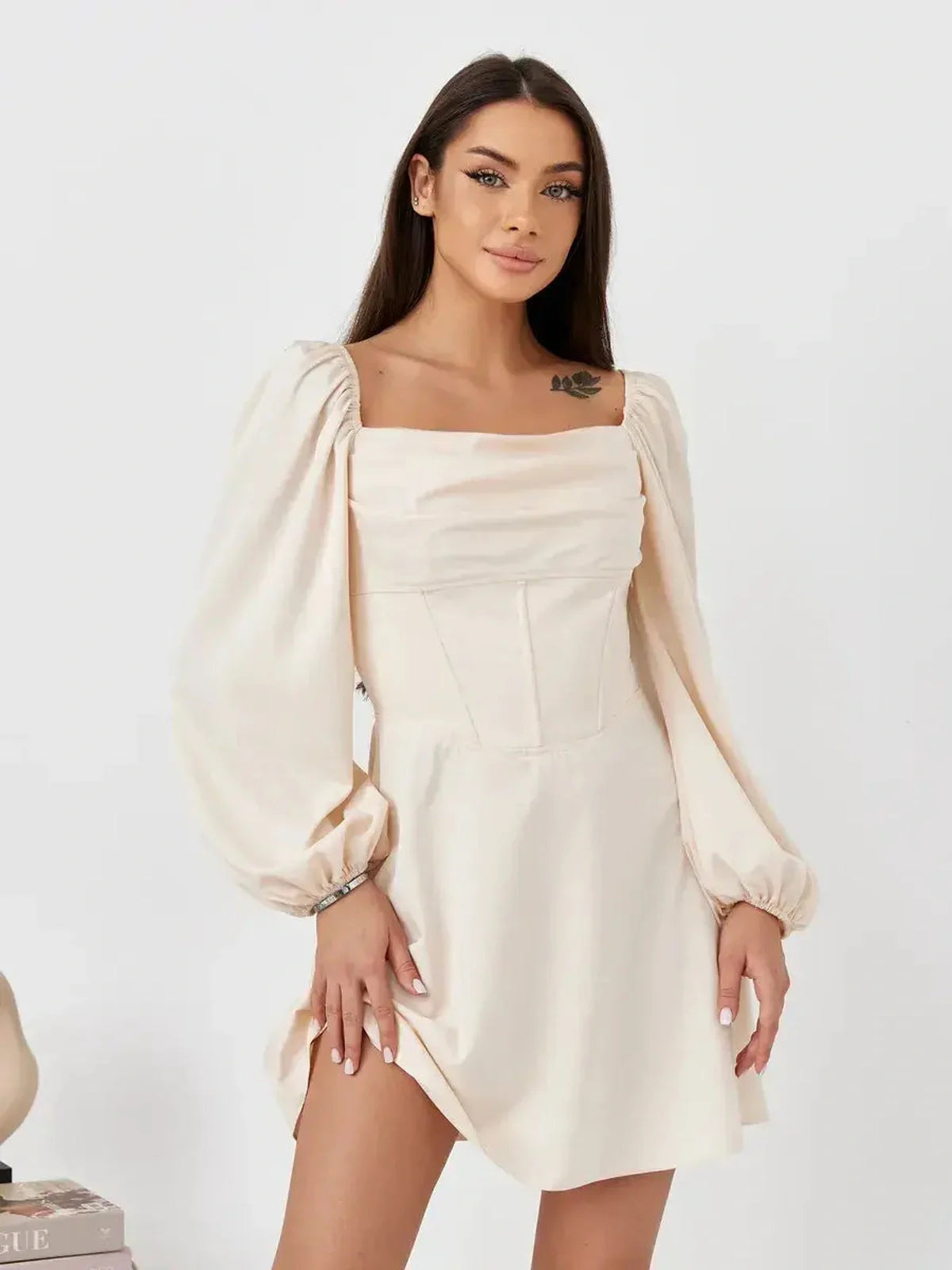 Lace Muse beige mini dress featuring a fitted corset bodice and puff sleeves, exuding effortless elegance.