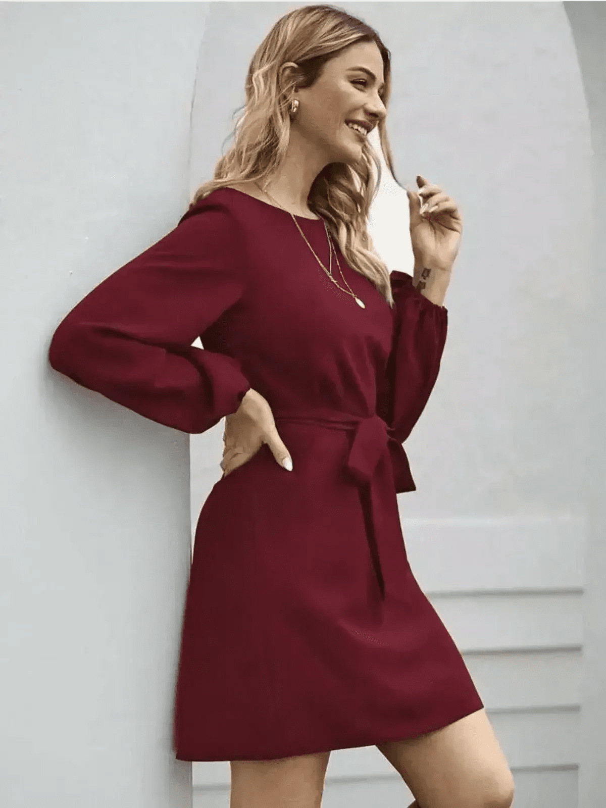 Elegant burgundy mini dress with long sleeves and a cinched waist, perfect for summer or formal occasions.