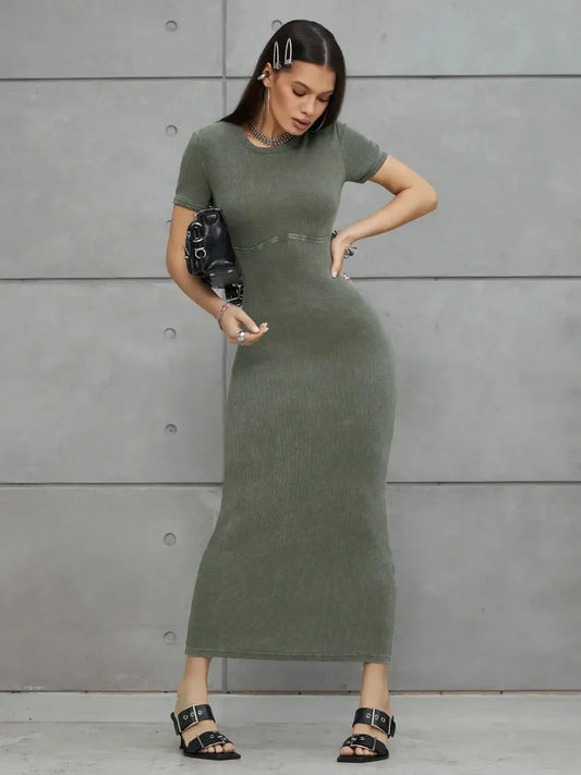 Olive Line Maxi Dress in khaki green ribbed cotton, featuring a fitted ankle-length silhouette and stylish accessories.
