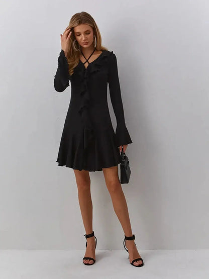 Elegant black Velvet Noir midi dress with V-neckline and ruffles, perfect for weddings or evening events.