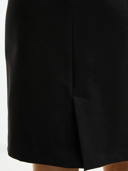 Close-up of a sleek black dress hemline with a subtle slit detail, showcasing elegant style and sophistication.