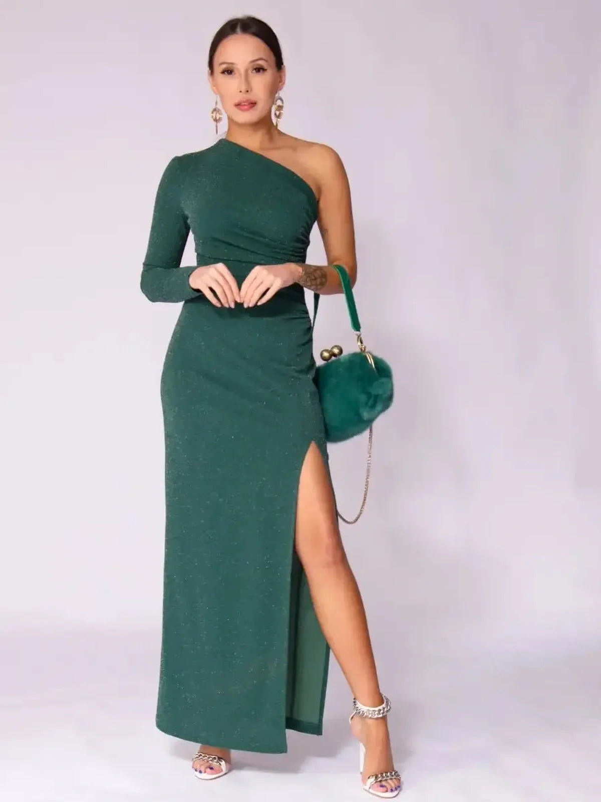 Emerald Spark Maxi Dress with one-shoulder design, high side slit, and shimmering green fabric for elegant styling.