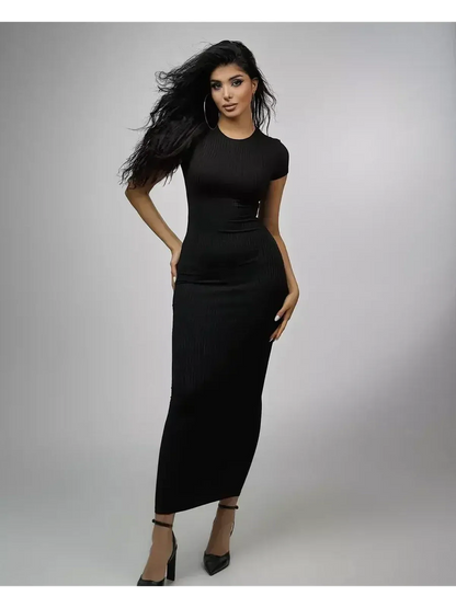 Model showcasing the Obsidian Maxi Dress in black, featuring a sleek ribbed knit and stylish silhouette.