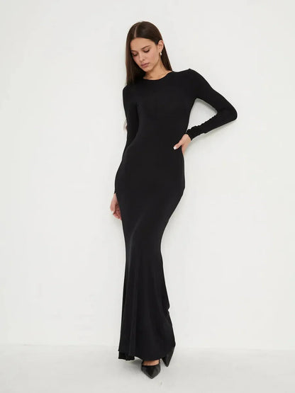 Elegant full-length black dress, Sculpted Noir, featuring a second-skin fit and mermaid hem for a sleek silhouette.