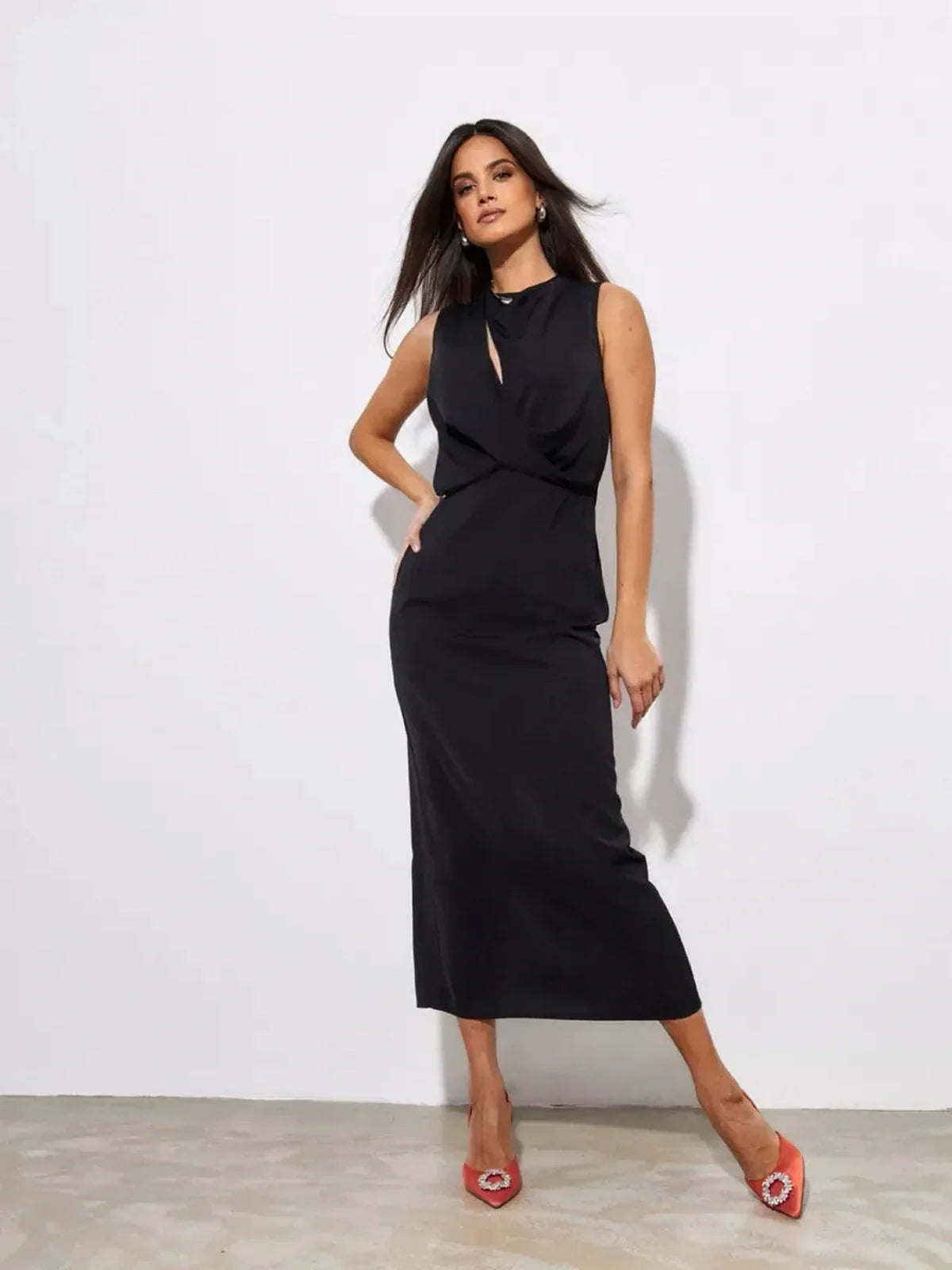 Model showcasing the Noir Drape Maxi Dress, a sophisticated black gown perfect for elegant events.