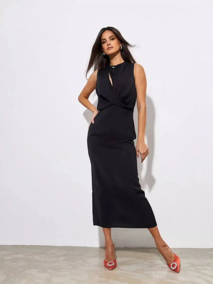 Model showcasing the Noir Drape Maxi Dress, a sophisticated black gown perfect for elegant events.