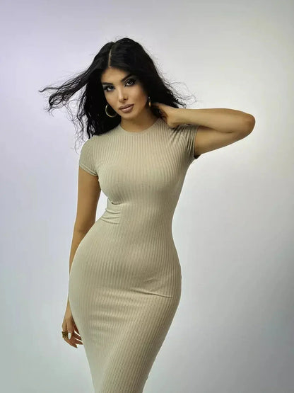 Model showcasing the beige Maxi Dress Contour Grace, featuring a ribbed texture and sculpted fit.