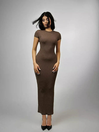 Chocolate-hued ribbed maxi dress with sculpted contour and sleek silhouette, embodying modern minimalism.