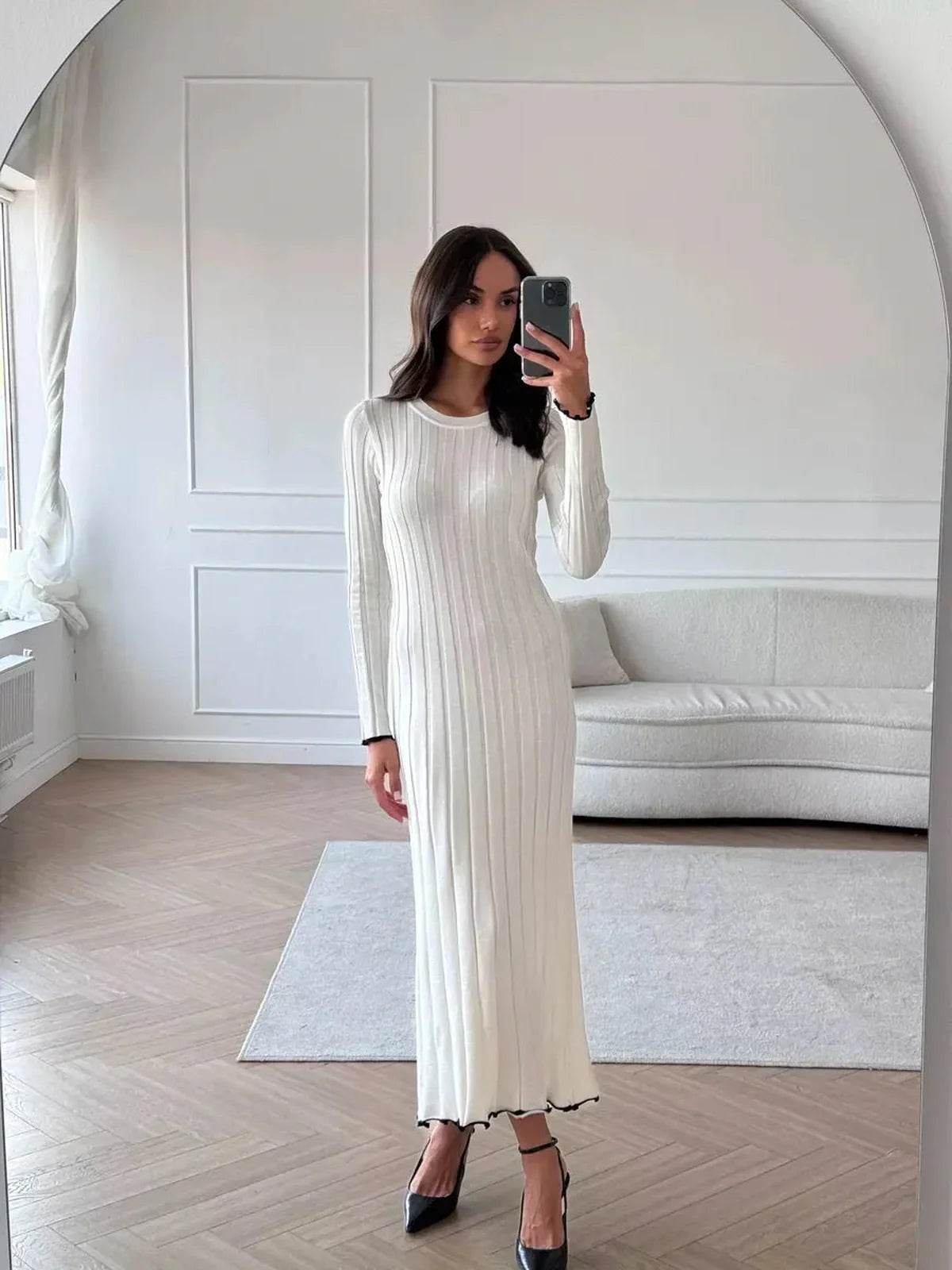 Model wearing the Ivory Grace Maxi Dress, showcasing its elegant ribbed texture and delicate ruffle trim.