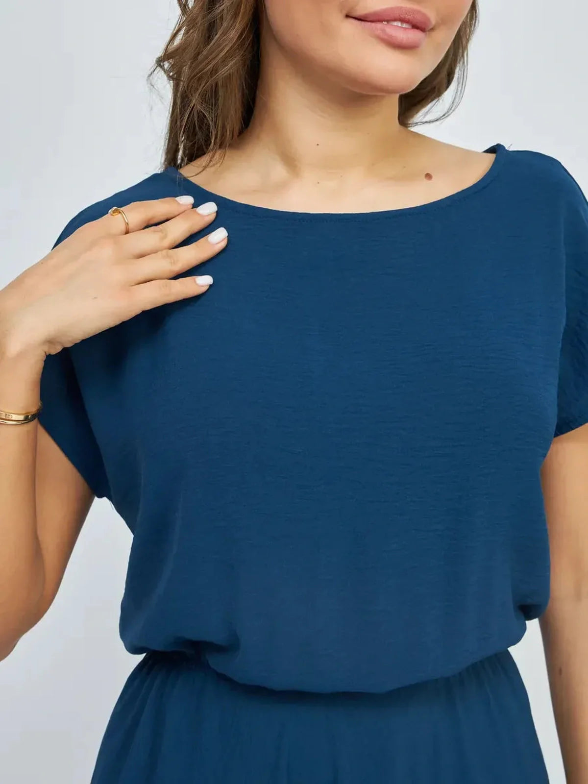 Close-up of a woman wearing a blue Verona Maxi Dress showcasing its lightweight fabric and elegant neckline.