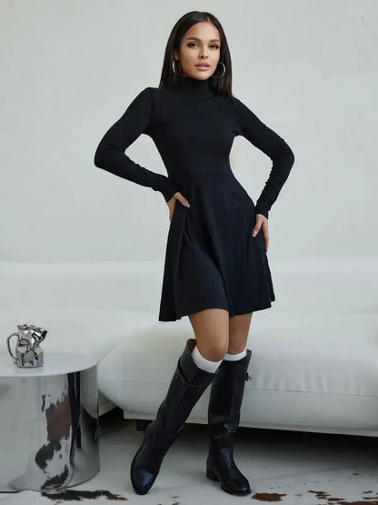 Elegant black ribbed mini dress with high stand collar, styled for versatility with knee-high boots.
