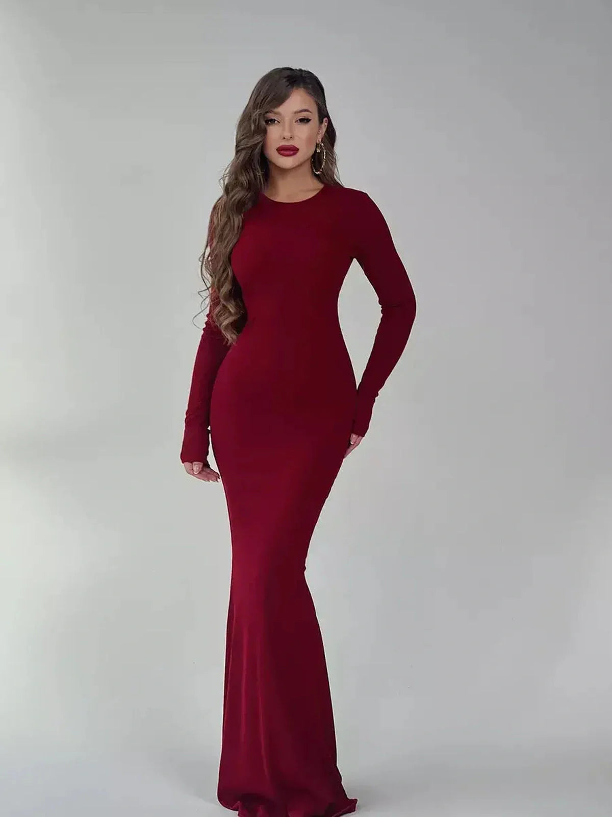 Elegant burgundy long sleeve maxi dress featuring a sleek silhouette and luxe stretch fabric.
