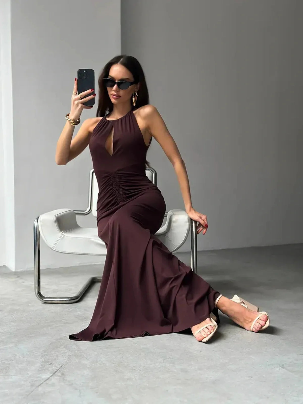 Model showcasing the elegant Maxi Dress Sienna with a halter neckline and figure-flattering ruching in a rich shade.