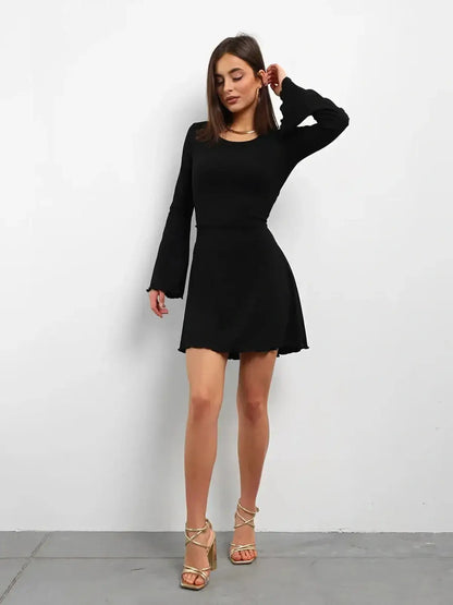 Black laced mini dress with long sleeves, perfect for summer or cocktail parties.