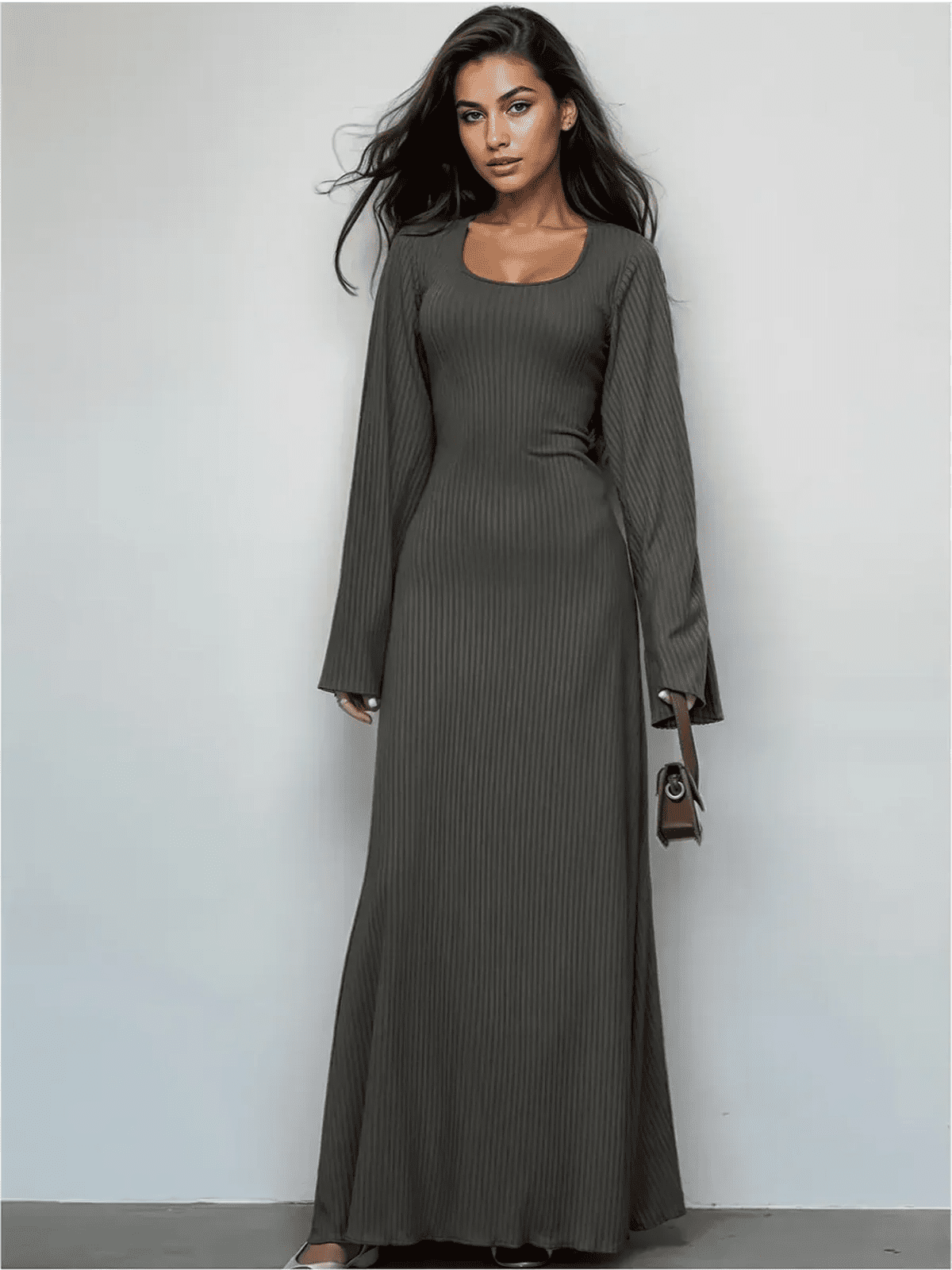 Elegant granite luxe maxi dress with a sculpting fit and flared sleeves, perfect for day-to-dusk styling.