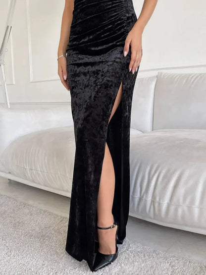 Noir Muse Maxi Dress in black velvet showcasing a sultry thigh-high slit and elegant sculpted fit.