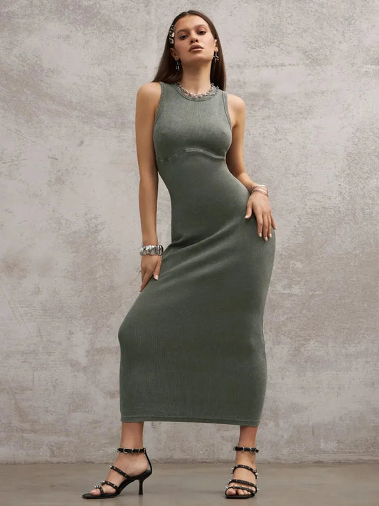 Model wearing the Verdant Curve Maxi Dress in washed khaki, showcasing sleek design and a fitted silhouette.