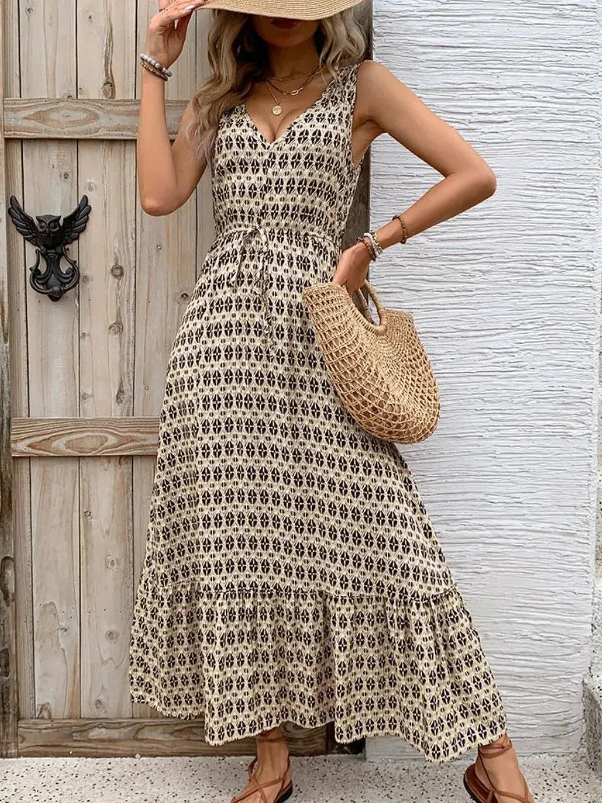 Solana Maxi Dress featuring a boho-inspired print, V-neckline, and tiered skirt, perfect for summer outings.