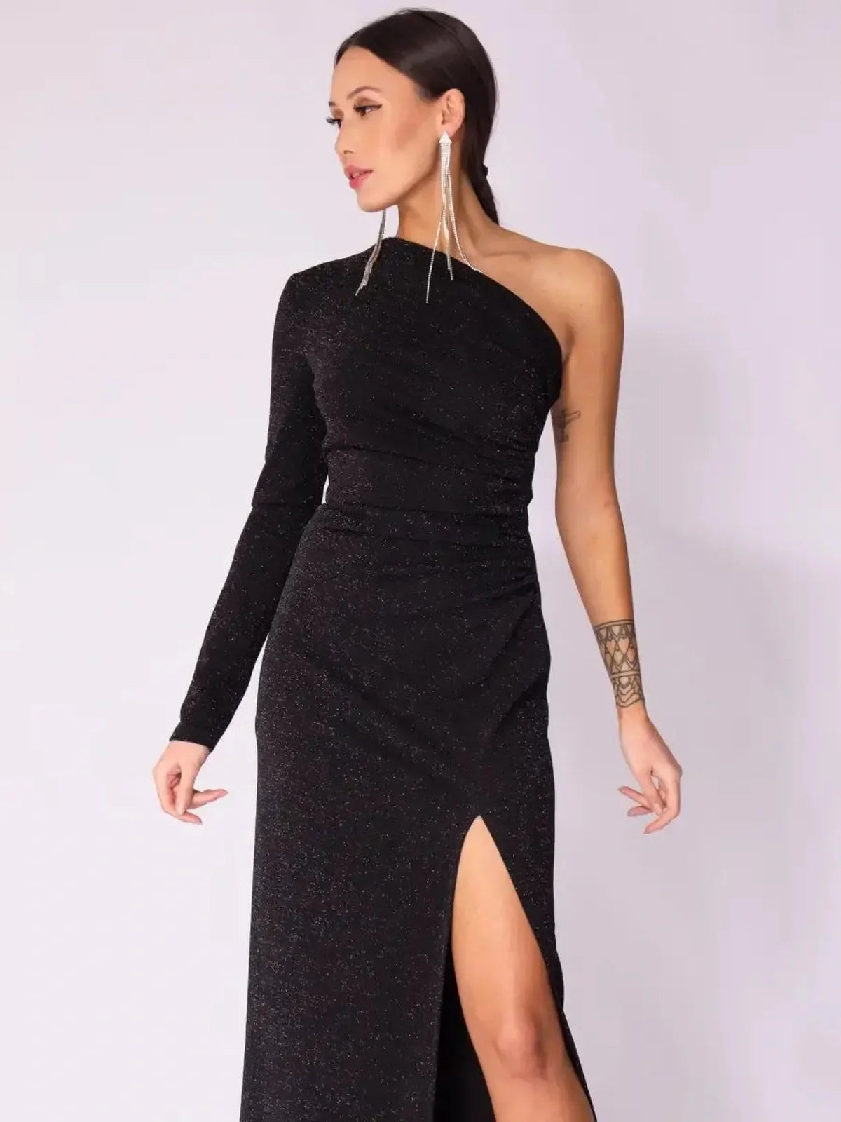 Luna Noir Maxi Dress in black with one-shoulder design, shimmering fabric, and daring leg slit, perfect for evening elegance.