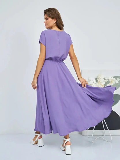 Woman wearing a flowing lavender maxi dress with gathered waist, perfect for summer elegance and comfort.