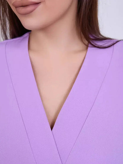 Close-up of a model wearing a lilac dress featuring a flattering V-neckline for an elegant look.
