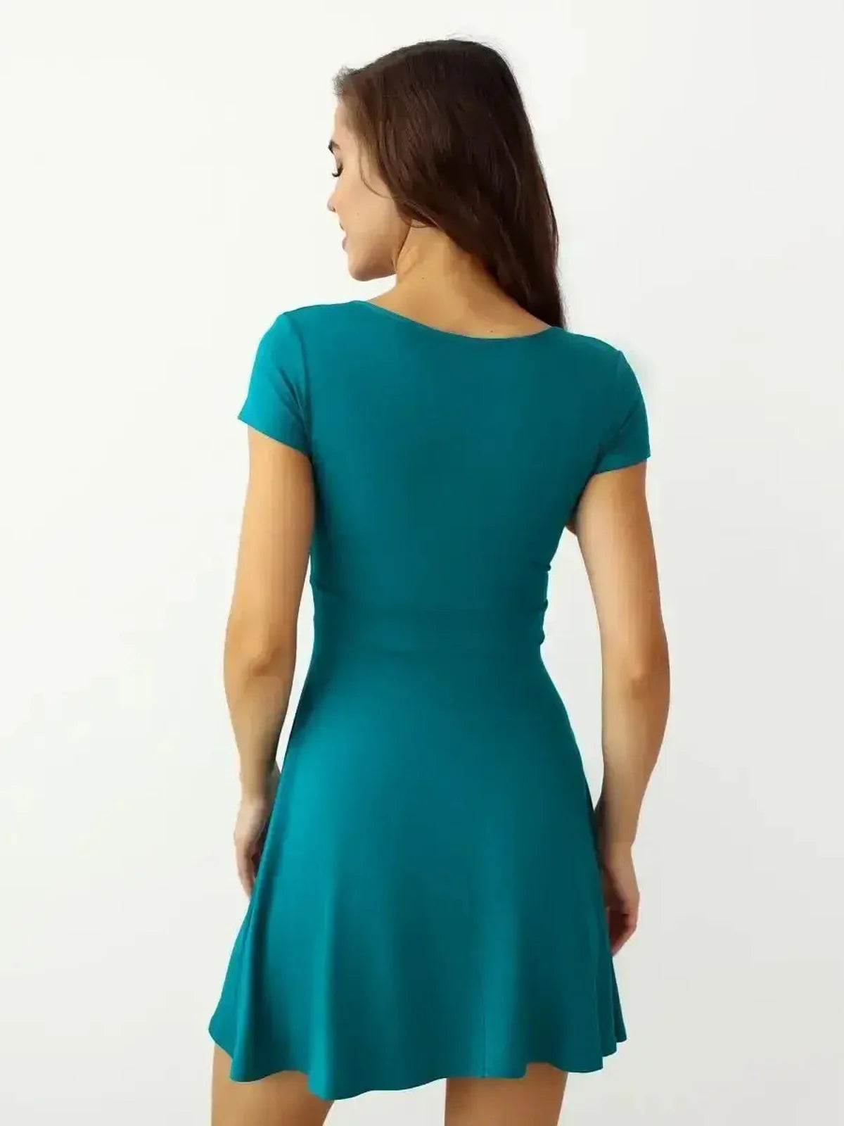 Back view of the Ocean Wrap mini dress in teal, showcasing its short sleeves and wrap-style silhouette.