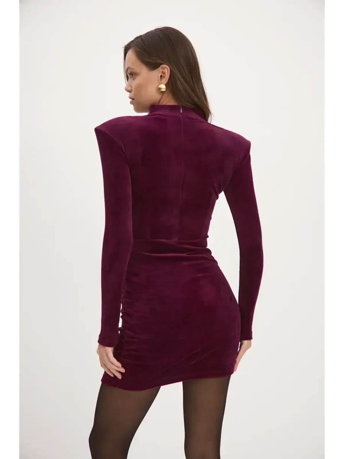 Rear view of a burgundy Velvet Aura mini dress with long sleeves and strong shoulder design.