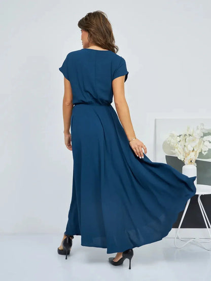 Verona Maxi Dress in deep blue, showcasing the back view with flowing skirt and cinched waist, perfect for summer elegance.