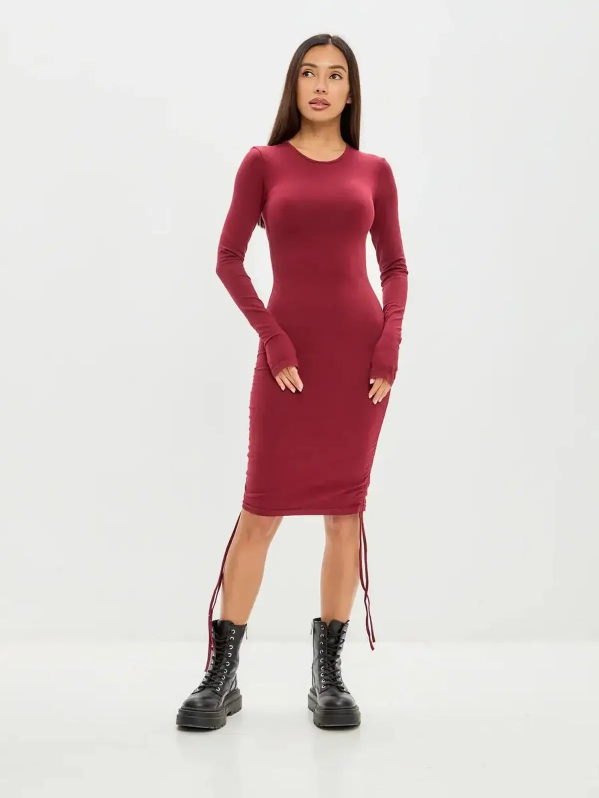 Burgundy long sleeve mini dress featuring side draping and a high-stretch cotton blend for a bold, confident look.